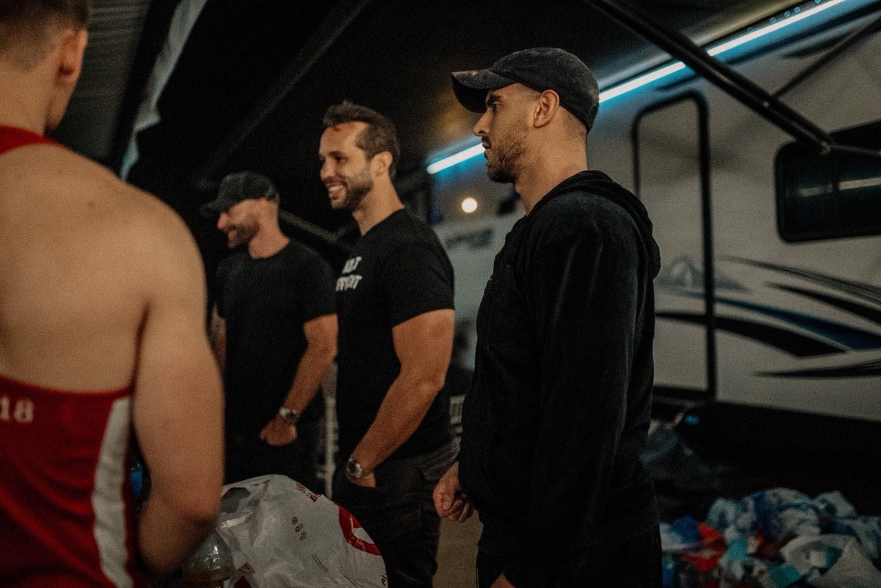 Ty standing with a group behind the scenes at an event