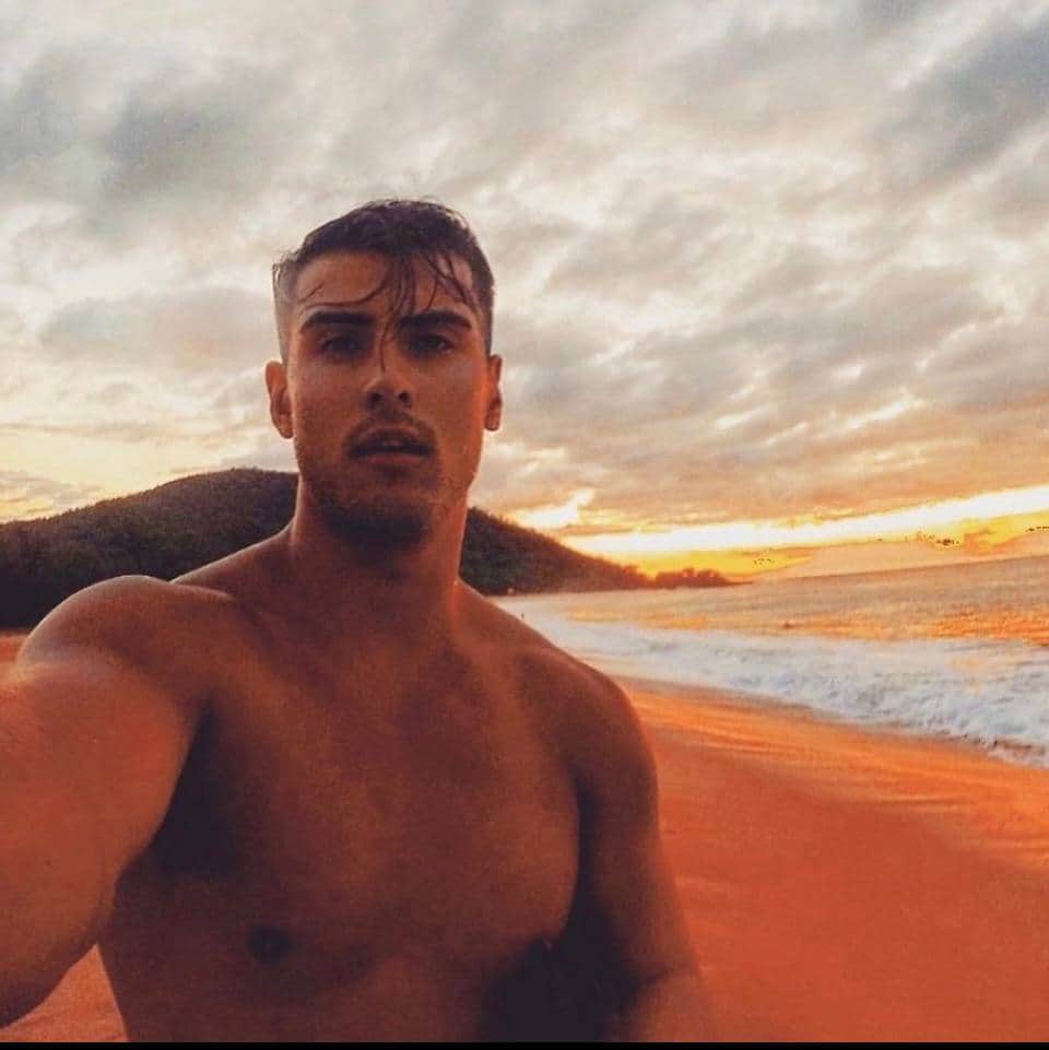 Ty on a beach at sunset