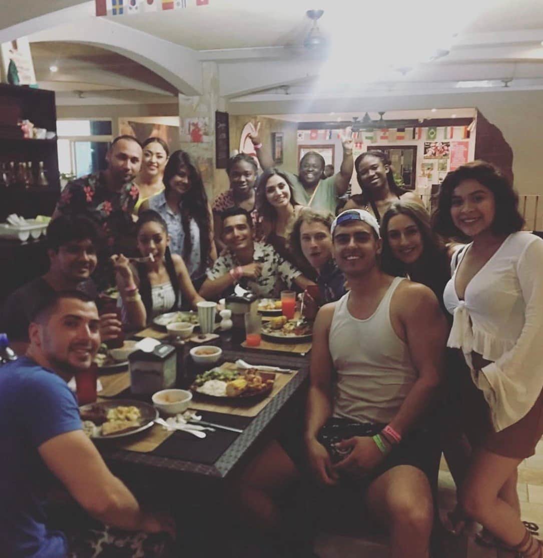 Ty at a long dinner table with a big group